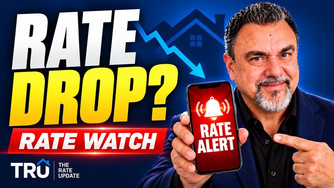 Rate Watch: Dan Frio holding a phone with a rate alert for when mortgage rates drop