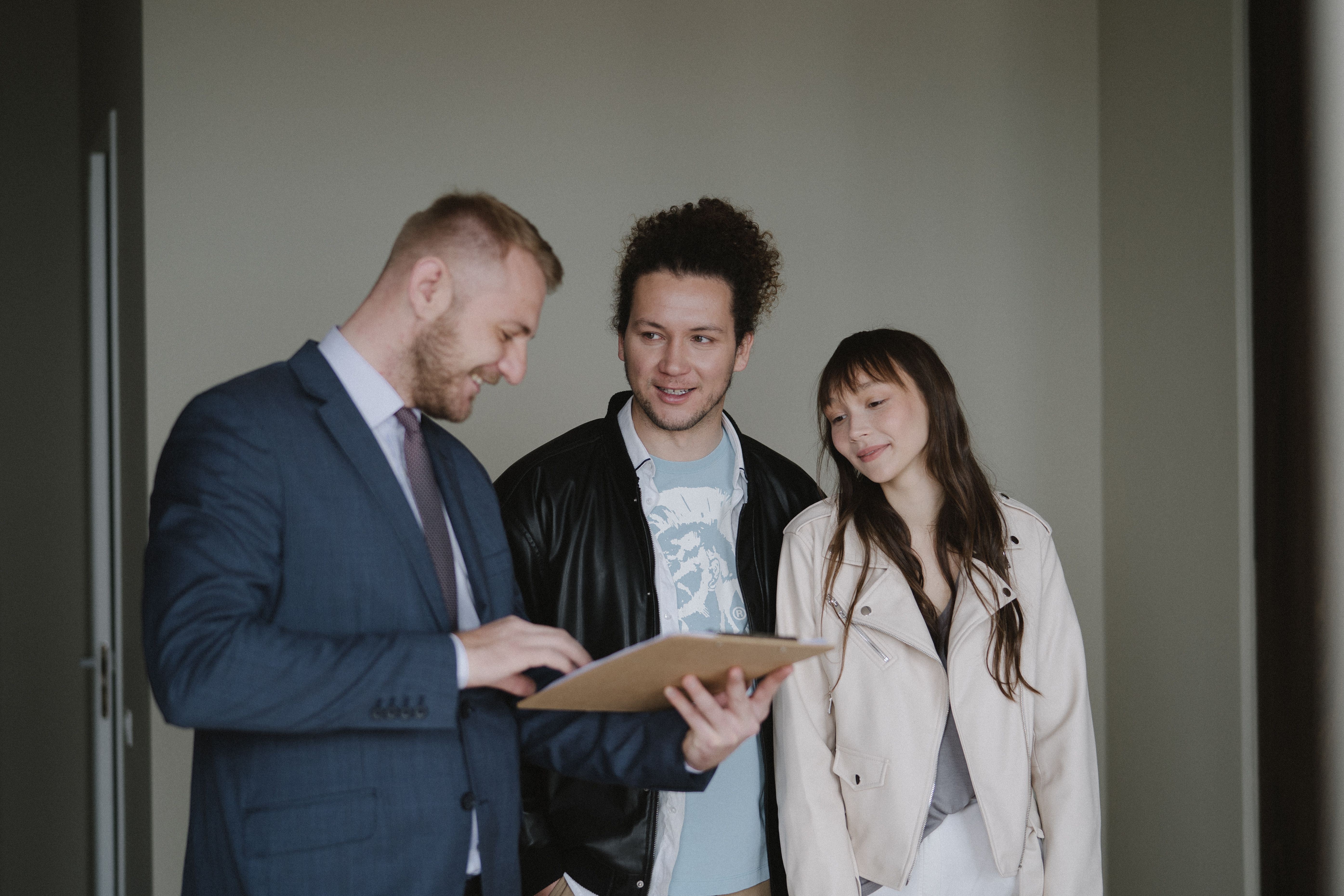 Couple talking with a real estate agent about their next steps.