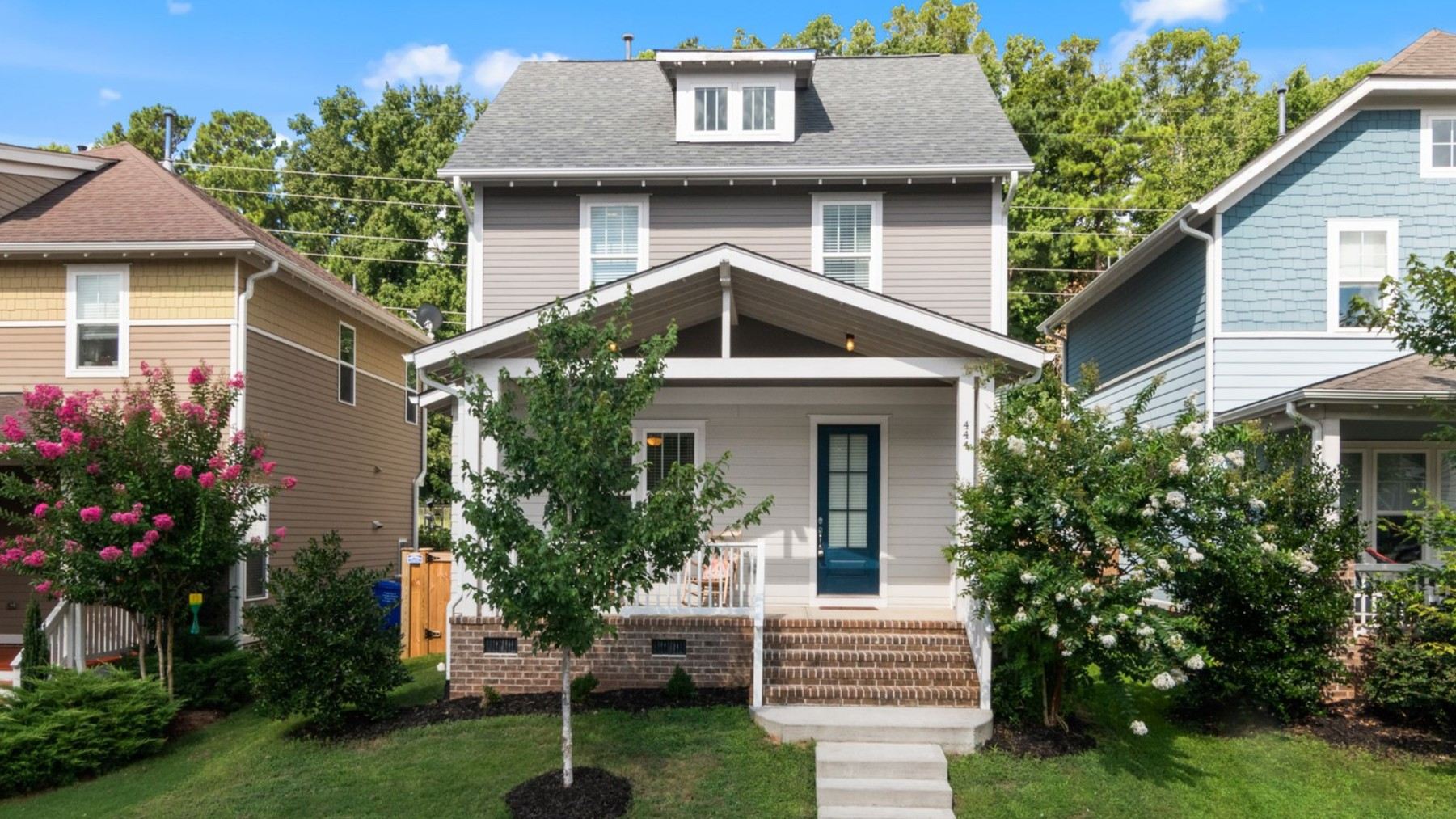 A beautiful suburban home A beautiful suburban home with a well-maintained lawn and vibrant surroundings.
