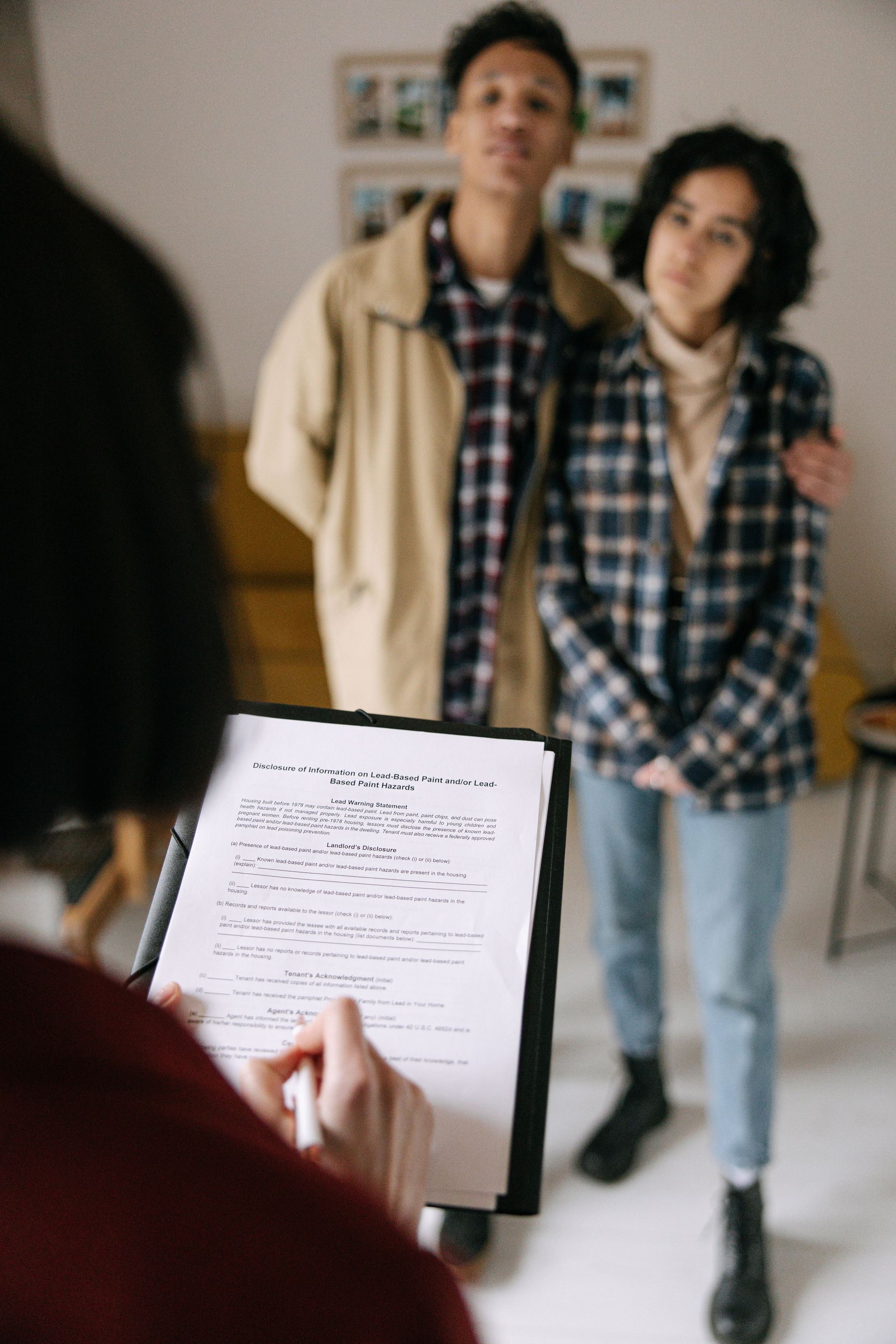 Couple discussing their homebuying plans with a real estate agent.